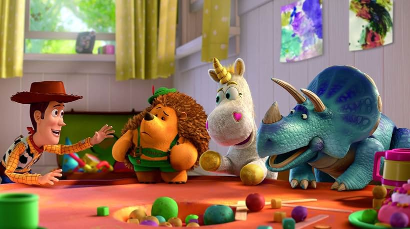 Tom Hanks, Timothy Dalton, Jeff Garlin, and Kristen Schaal in Toy Story 3 (2010)