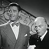 Errol Flynn and Grant Mitchell in Footsteps in the Dark (1941)