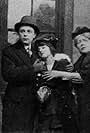 Harry Beaumont, Robert Brower, Margery Bonney Erskine, Gladys Hulette, and William West in His Chorus Girl Wife (1914)