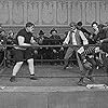 Charles Chaplin, Lloyd Bacon, Bud Jamison, and Ernest Van Pelt in The Champion (1915)