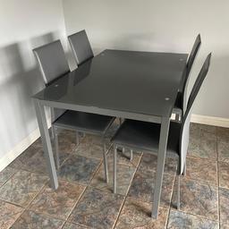 Great black glass table and grey chairs hardly used nice thing