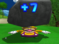 Wario receiving a +7 in Mario Golf: Toadstool Tour