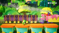 Yoshi fighting the Gator Train in the Yoshi's Crafted World boss level Gator Train Attacks!