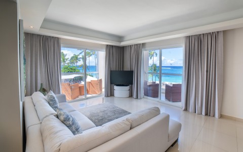 a living room with a large white couch and a television