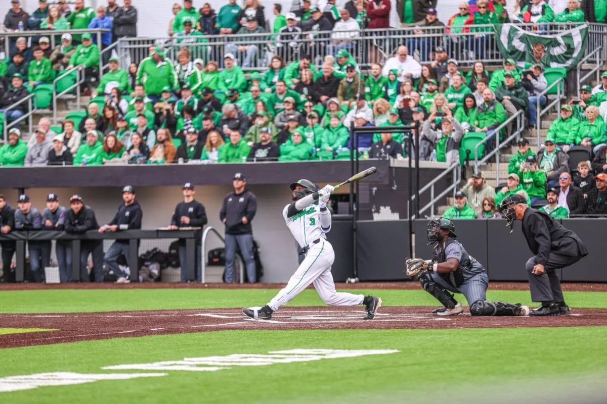 Tre Hondras swings for the fence during the opening pitch in the new stadium.