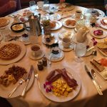 many plates of food on a large round table