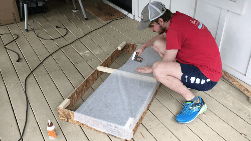 stapling cheap fabric to the back of the panel