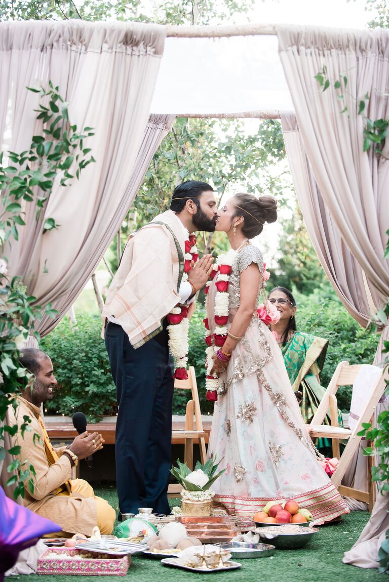 Couple kissing in mandap