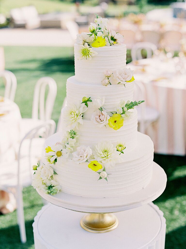 Four-tier spring wedding cake with yellow flowers