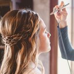 Woman getting airbrush makeup applied