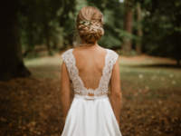 Bride with low bun braided wedding hairstyle