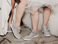 Brides wearing sparkly wedding sneakers on wedding day