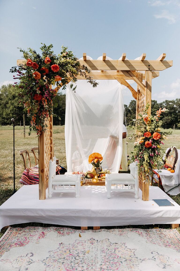 Wood pergola turned into rustic mandap with flowers