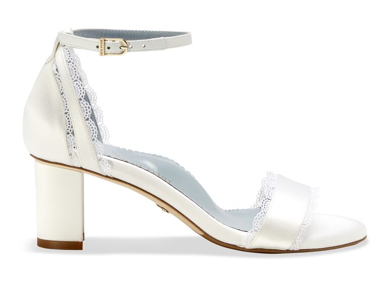 White block heeled shoes with lace trim by Sarah Flint. 