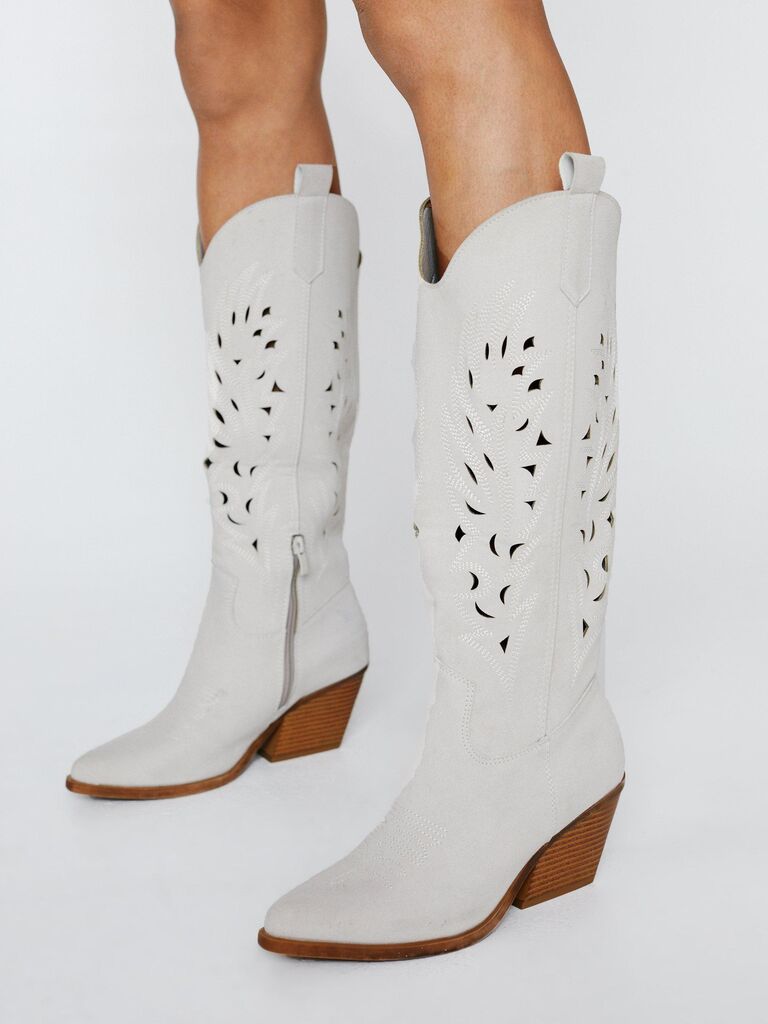 White cowboy boots with stylish cut outs. 