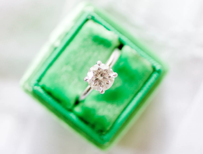 how to tell if a diamond ring is fake at home tests with a round-cut diamond ring in a green velvet ring box