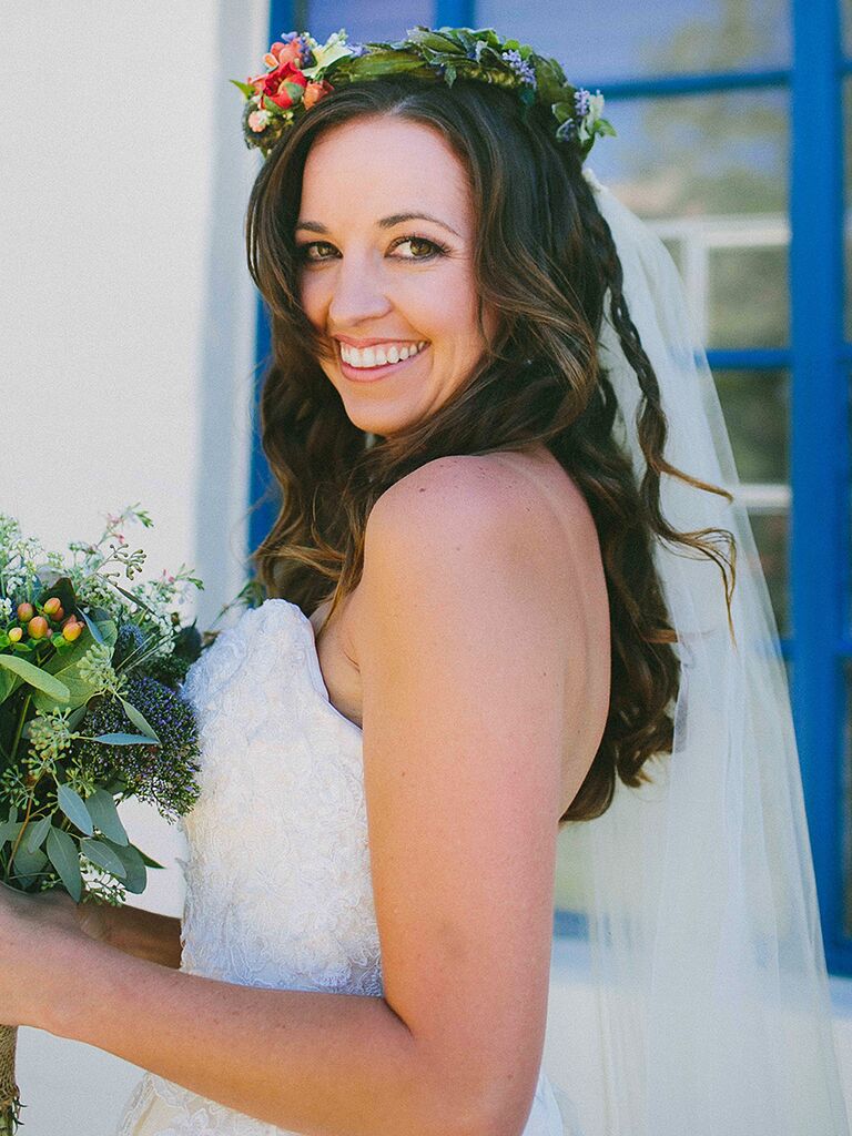 Long, loose curls with a wildflower wedding crown and veil