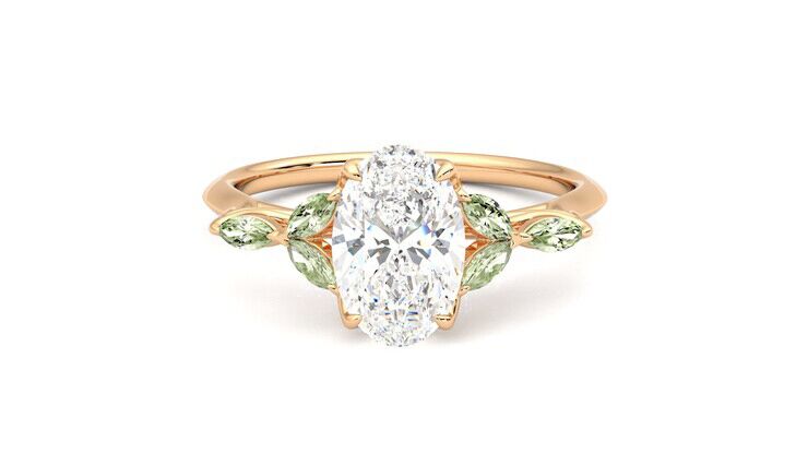 Oval diamond and green gem engagement ring