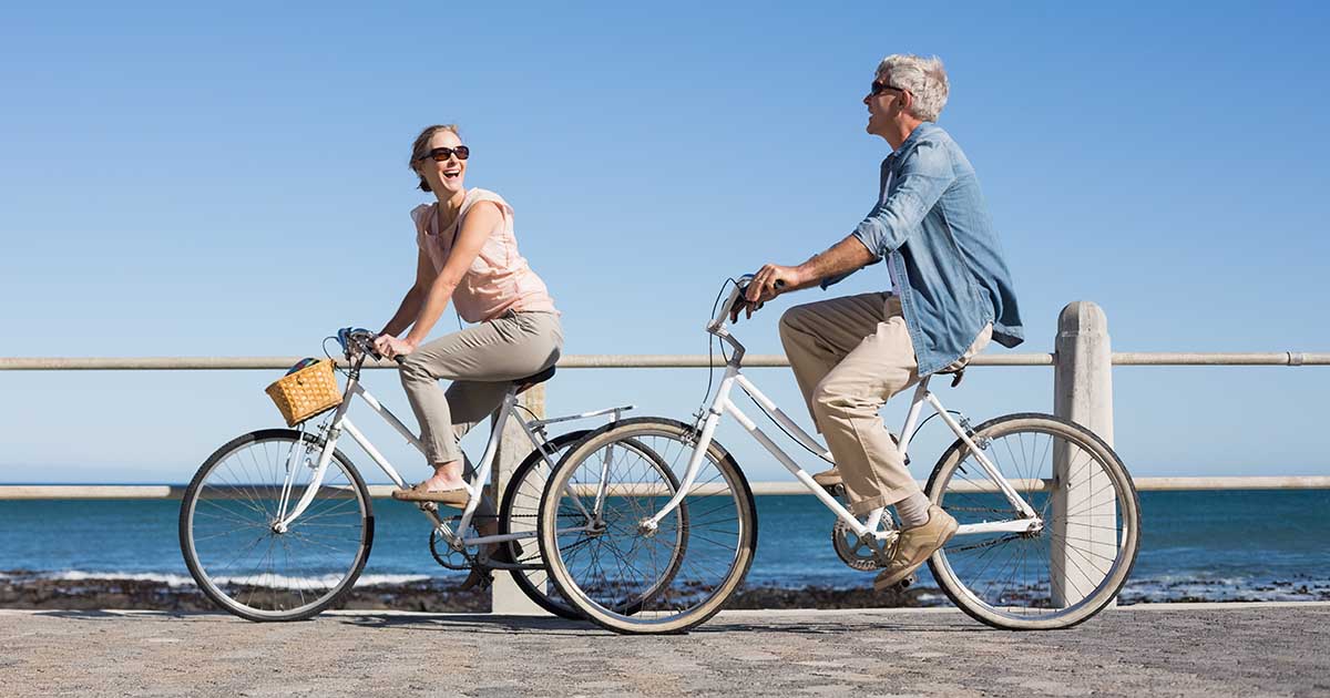 A couple is biking outside