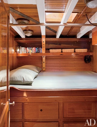 Image may contain Furniture Wood Housing Building Indoors Room Bedroom Hardwood Bed Plywood and Dorm Room