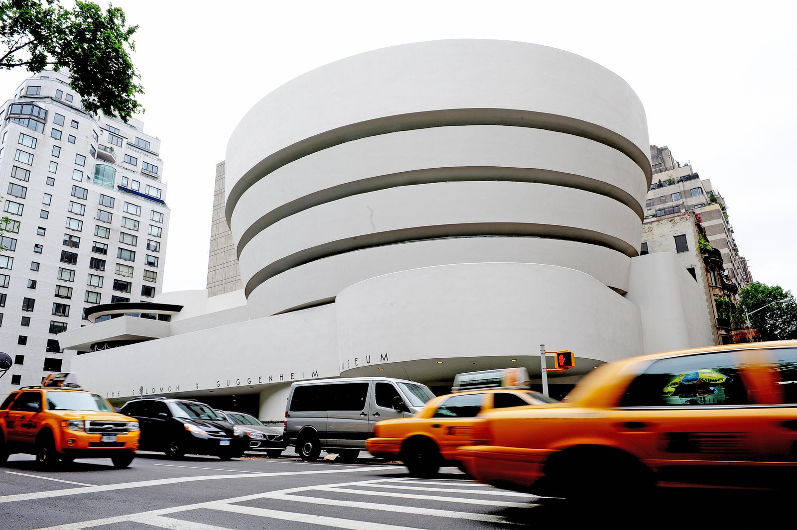 a round building with cabs outside