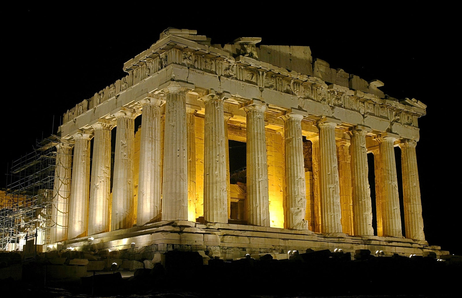 large building with ancient columns lit up at night