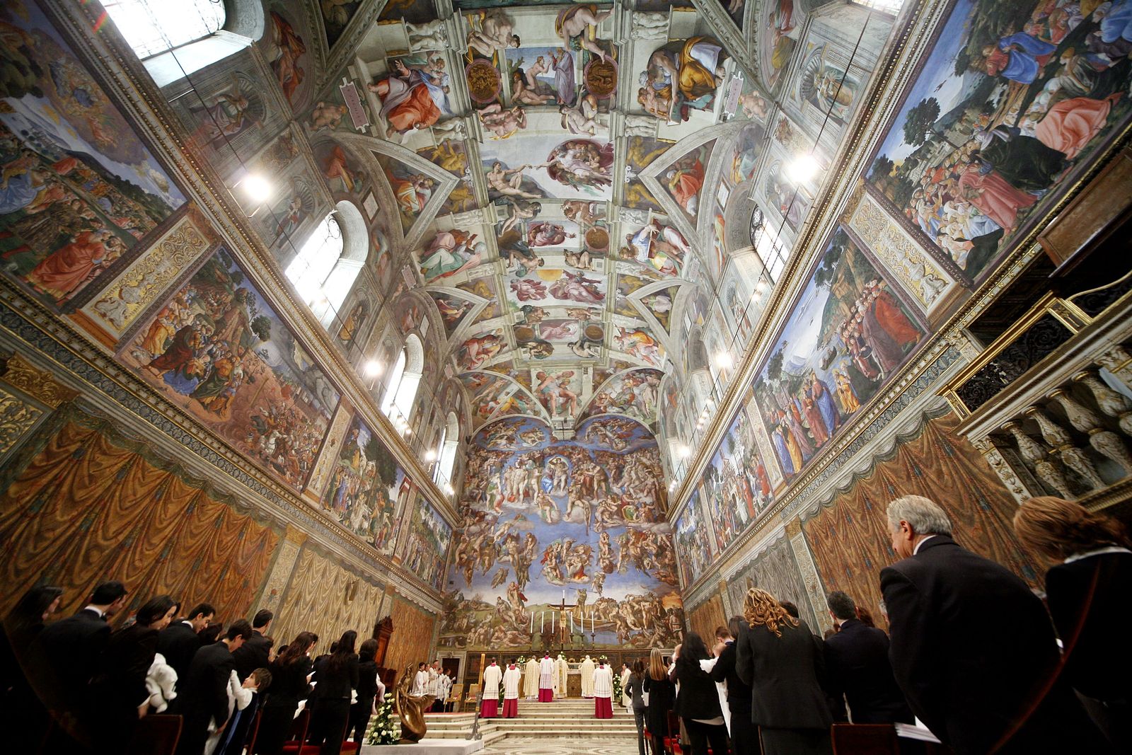 intricately painted ceiling with people standing below it