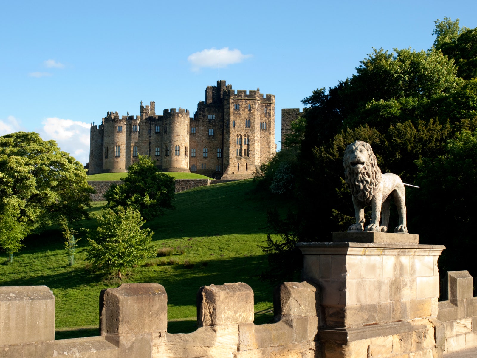 a large castle behind a stone wall