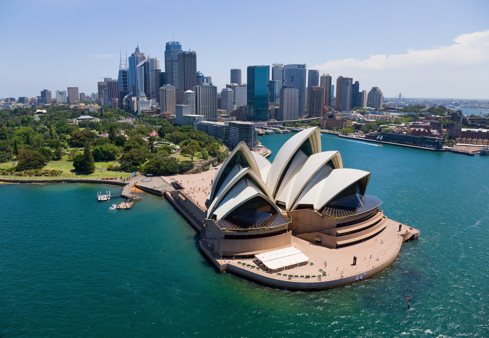 a building with arches in front of a city skyline