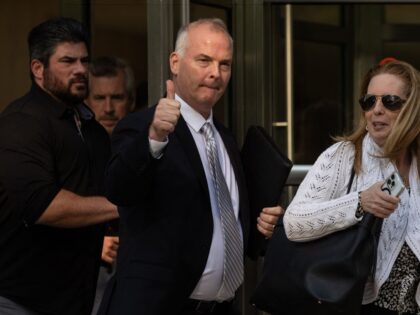 Retired NYPD sergeant Michael McMahon (C) leaves Brooklyn Federal Court in New York City o