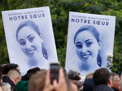 Attendees hold portait placards reading "Philippine could have been our sister" as people