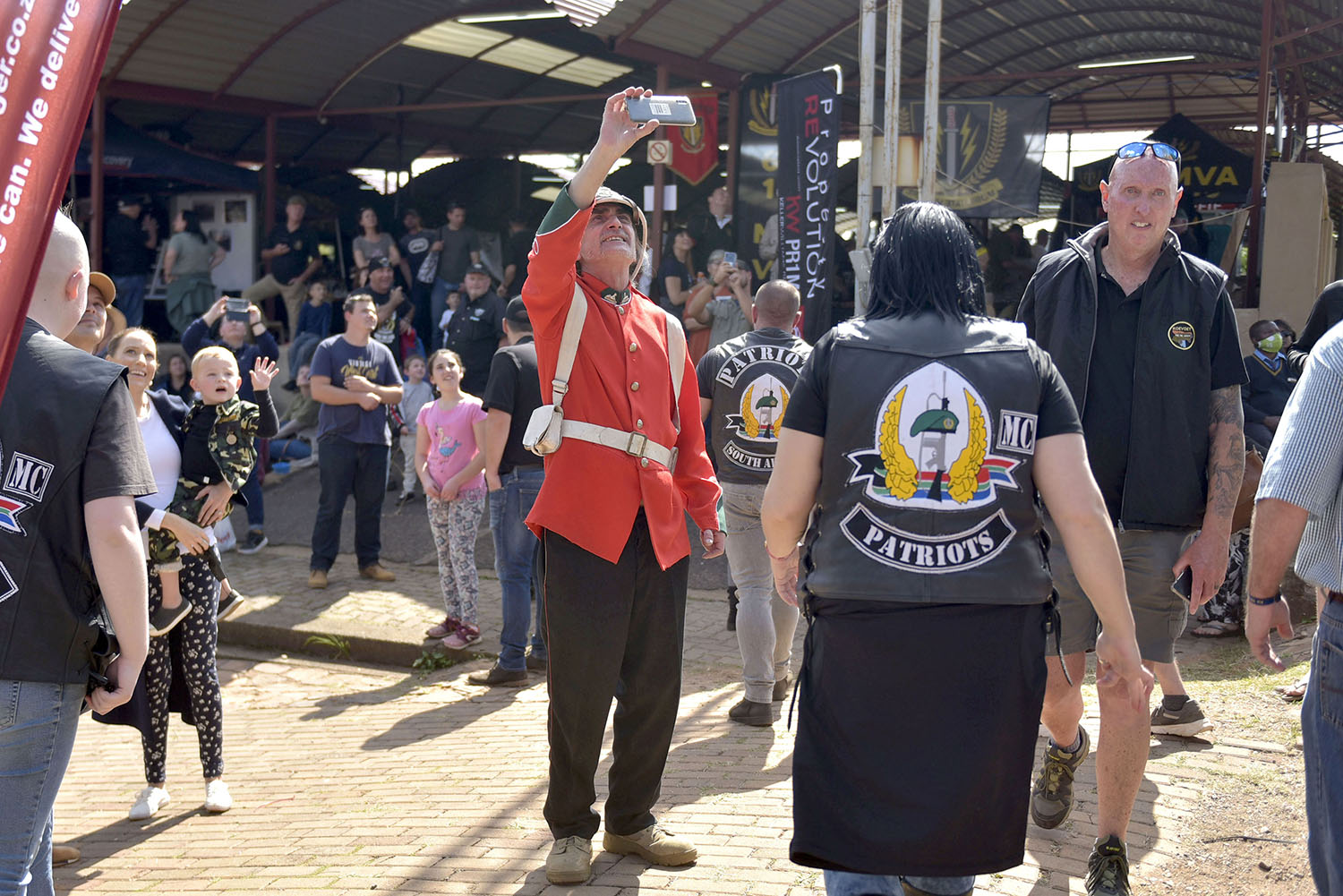 A military reenactor in British uniform records an Alouette doing an aerial display during the Pro Patria Military Fair held at the Voortrekker Monument yesterday, 2 May 2022. The festival brings a large spectrum of people together in a fair that incorporates military veterans associations, general military surplus sellers, reenactors and various other military history enthusiasts . Picture: Neil McCartney