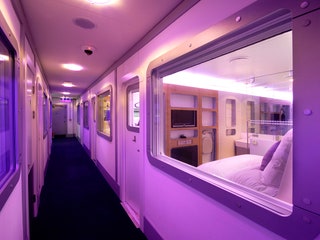 Image may contain Corridor Lighting Vehicle Transportation Train Furniture and Bed