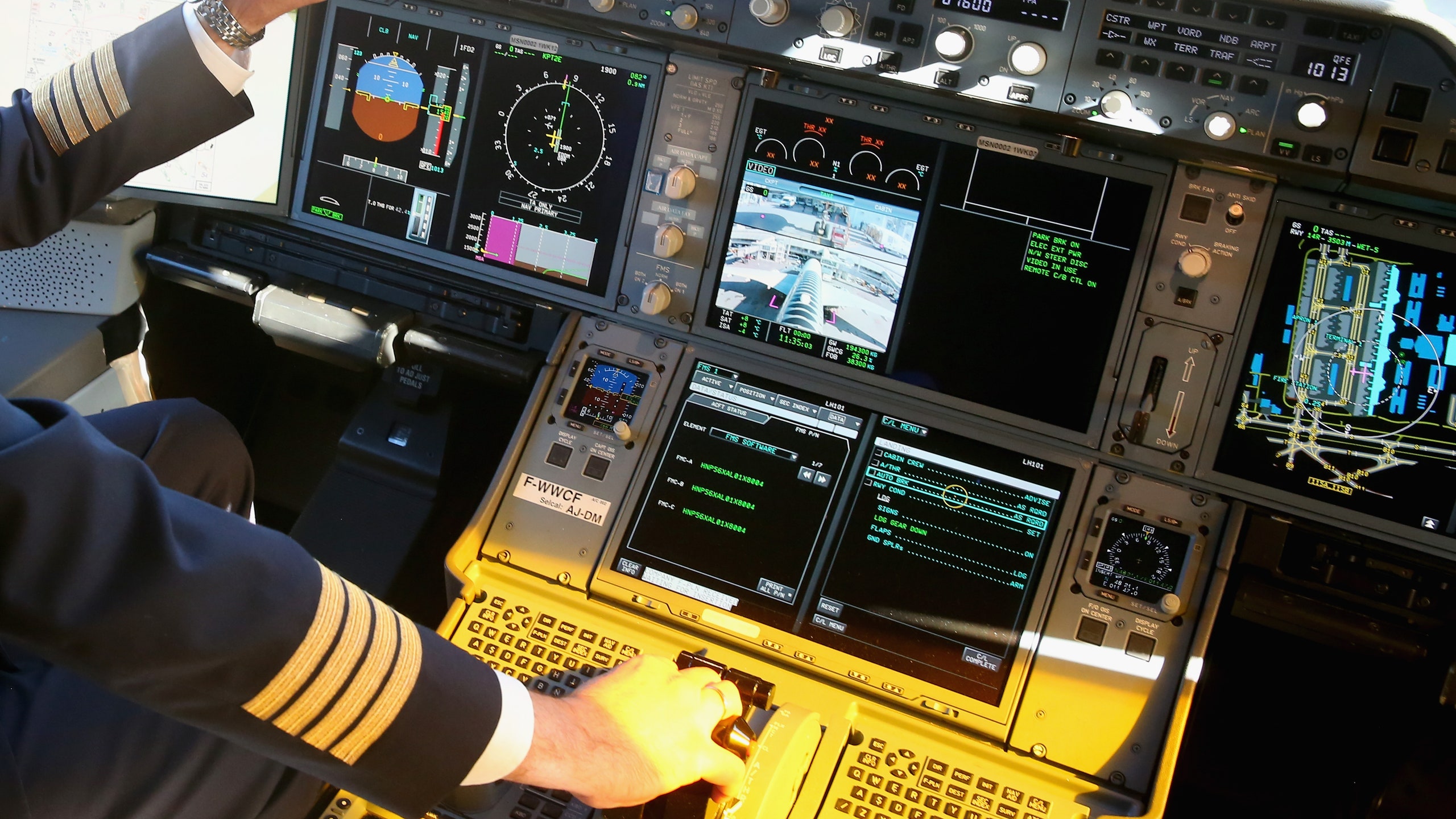 A pilot on the flight deck in the new Airbus A350X WB passenger plane as he stands on the tarmac at Munich Airport...