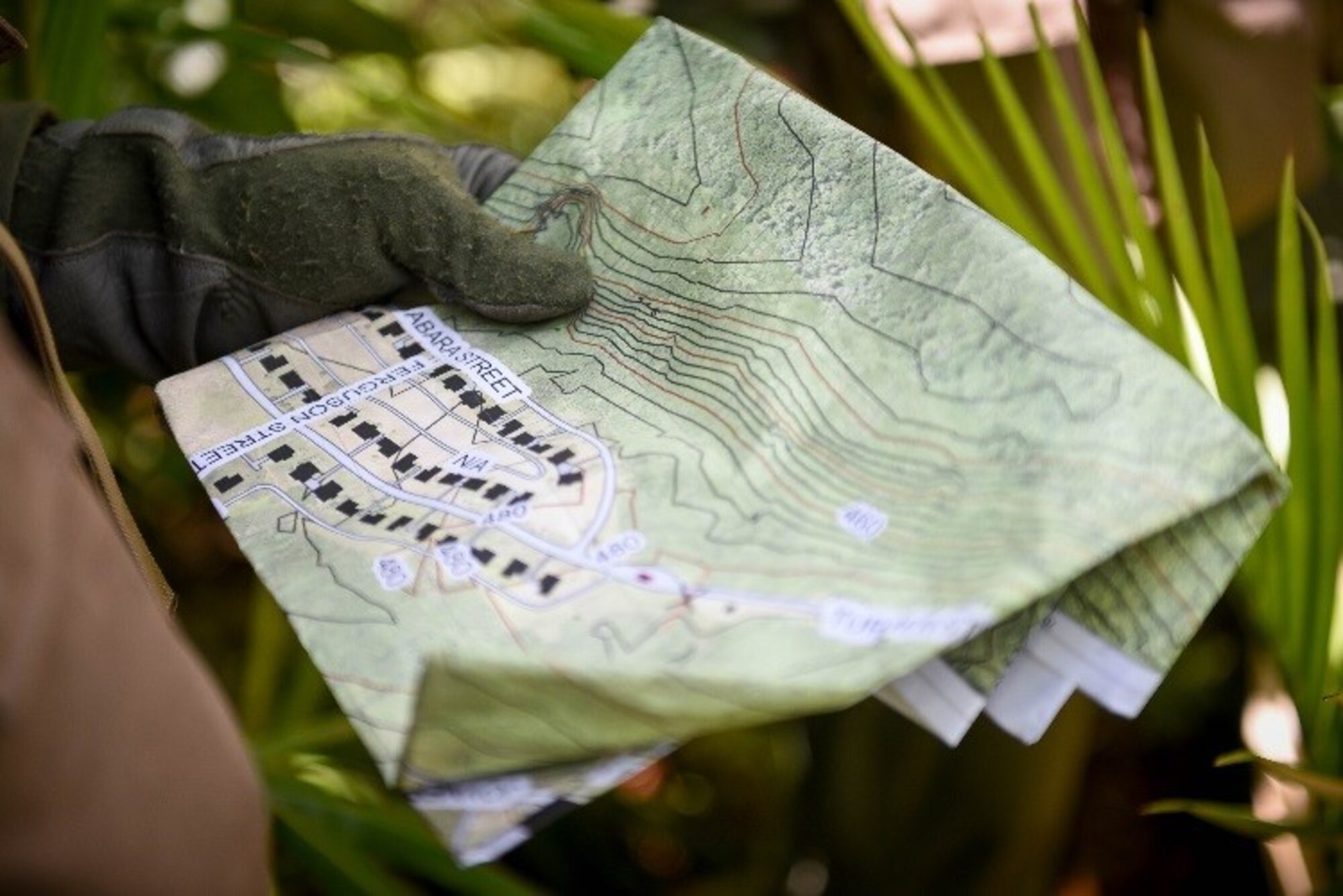 U.S. Air Force Col. Samuel White, 36th Operations Group commander, looks at an evasion map during a combat search and rescue training exercise June 5, 2017, at Andersen South, Guam. During the exercise, White acted as a downed pilot, along with three other Airmen, and was tested on his ability to survive and evade in a jungle environment. (U.S. Air Force photo by Staff Sgt. Joshua Smoot)
