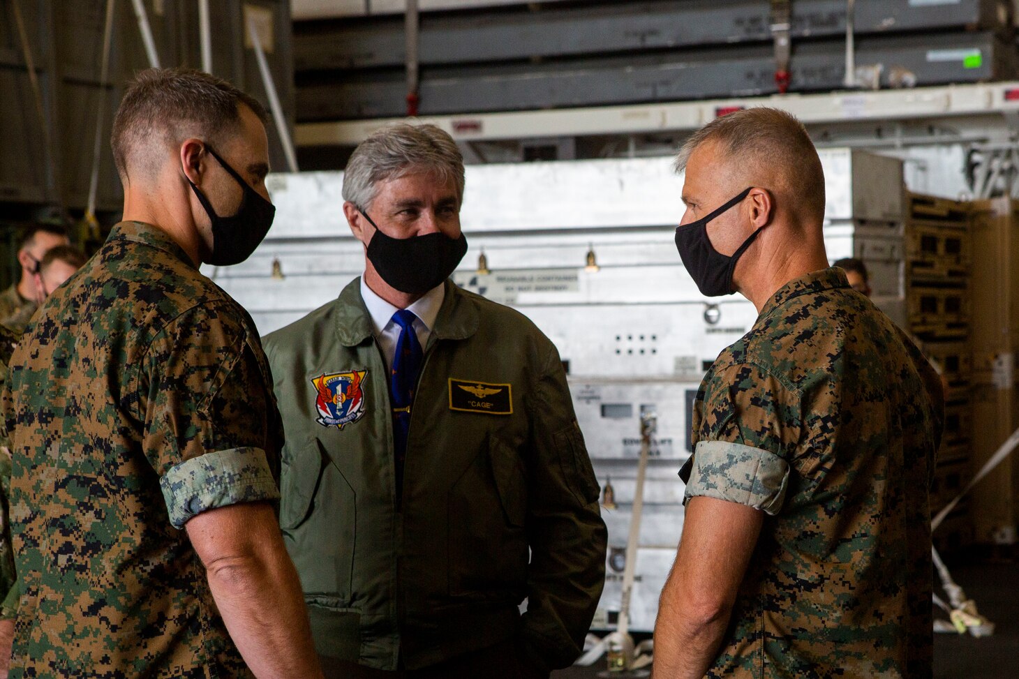 Secretary of the Navy (SECNAV) Kenneth J. Braithwaite speaks with U.S. Marine Corps Col. Christopher Bronzi, commanding officer of the 15th Marine Expeditionary Unit, right, and Maj. Daniel Davis, intelligence officer with the 15th MEU, during his visit to the amphibious assault ship USS Makin Island (LHD 8) in the eastern Pacific.