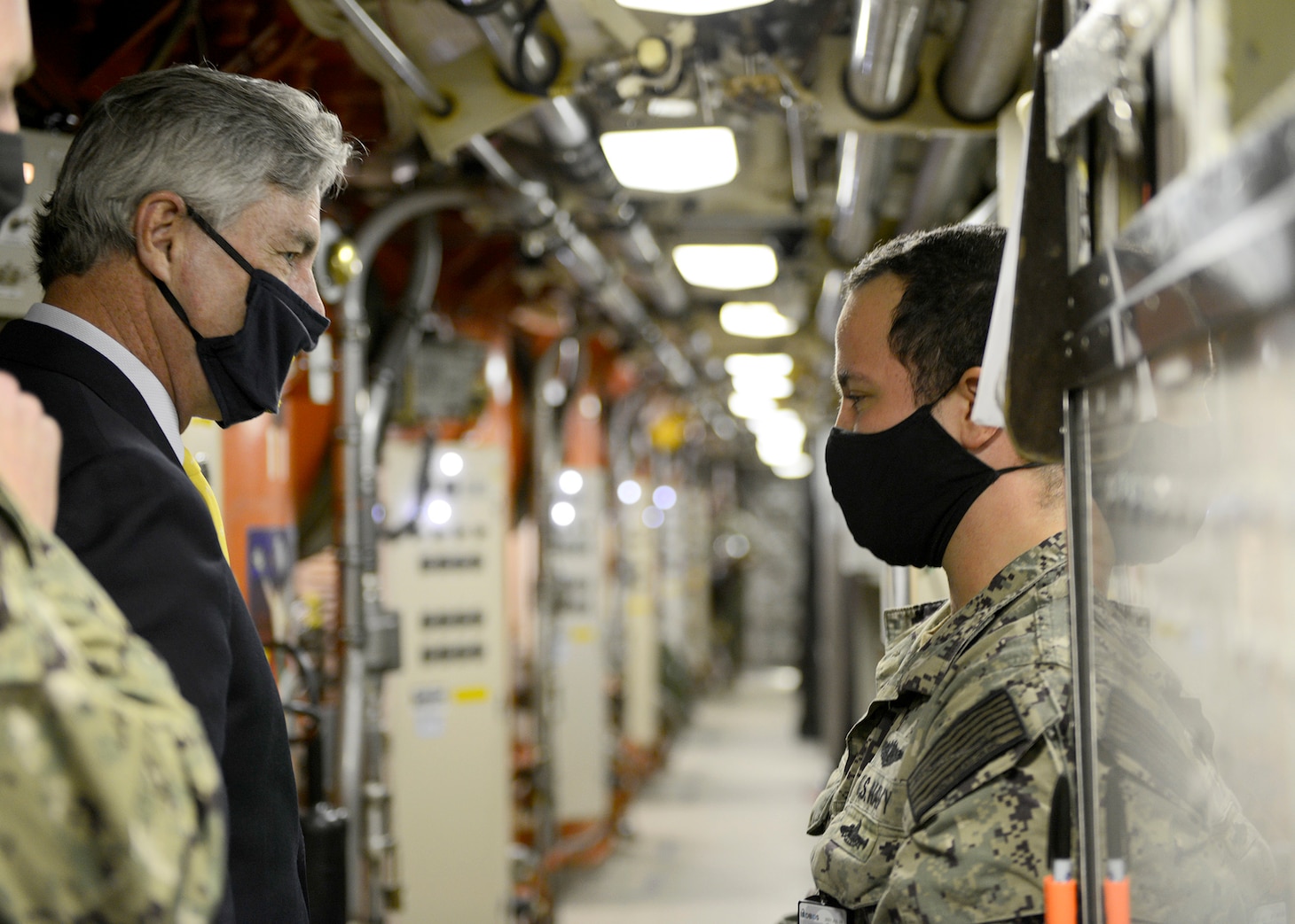 Secretary of the Navy Kenneth J. Braithwaite talks with Missile Technician 2nd Class Kain Hodgson aboard the Ohio-class ballistic-missile submarine USS Rhode Island (SSBN 740) (Blue) during his visit to Naval Submarine Base Kings Bay, Ga.