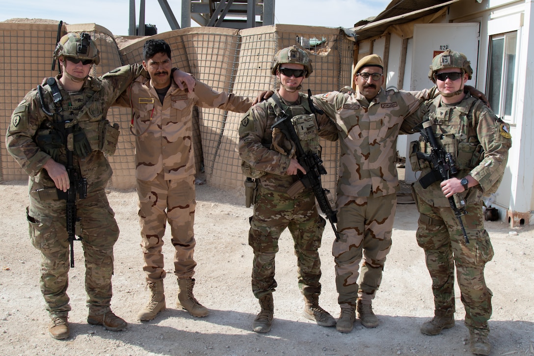 U.S. Soldiers with 1st Battalion, 5th Infantry Regiment, 1st Stryker Brigade Combat Team, 25th Infantry Division, take a photo with Iraqi troops guarding the perimeter of Al Asad Airbase in western Iraq, Feb. 15, 2020. U.S. troops regularly share food and other supplies, as well as tactics and procedures with Iraqi troops to reinforce the security partnership between the two nations. (U.S. Army photo by Sgt. Sean Harding)