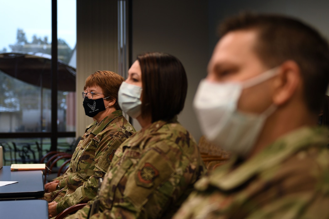 Airmen sit at a table.