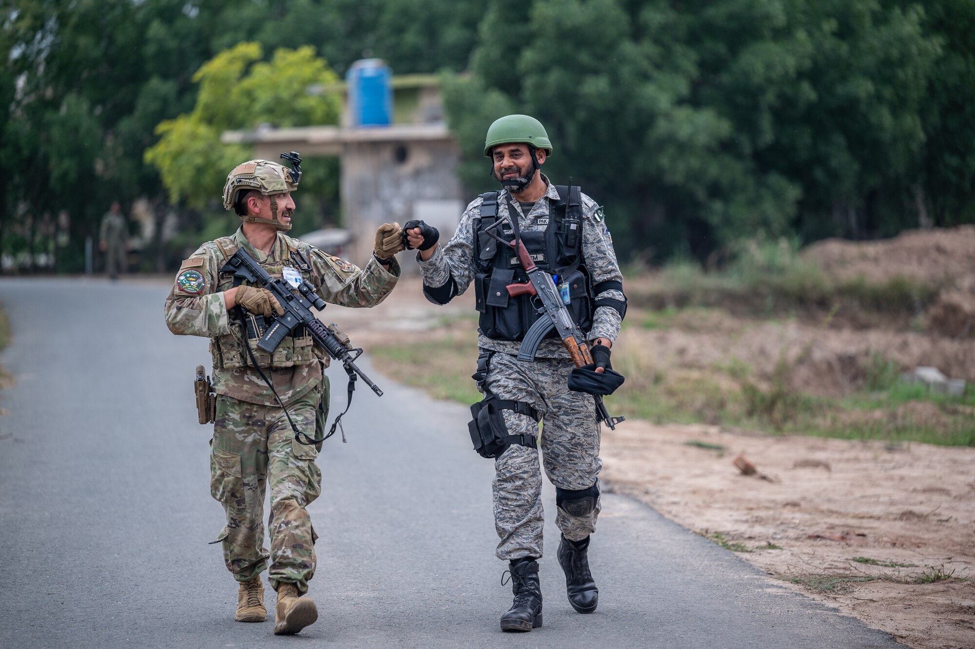 A U.S. Air Force member and a Pakistan Air Force member fist bump.