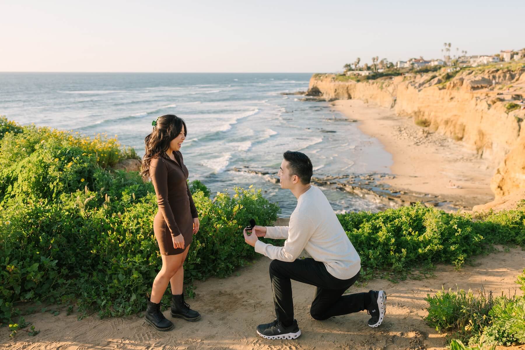 A couple getting engaged in San Diego on a surprise proposal photoshoot with Flytographer