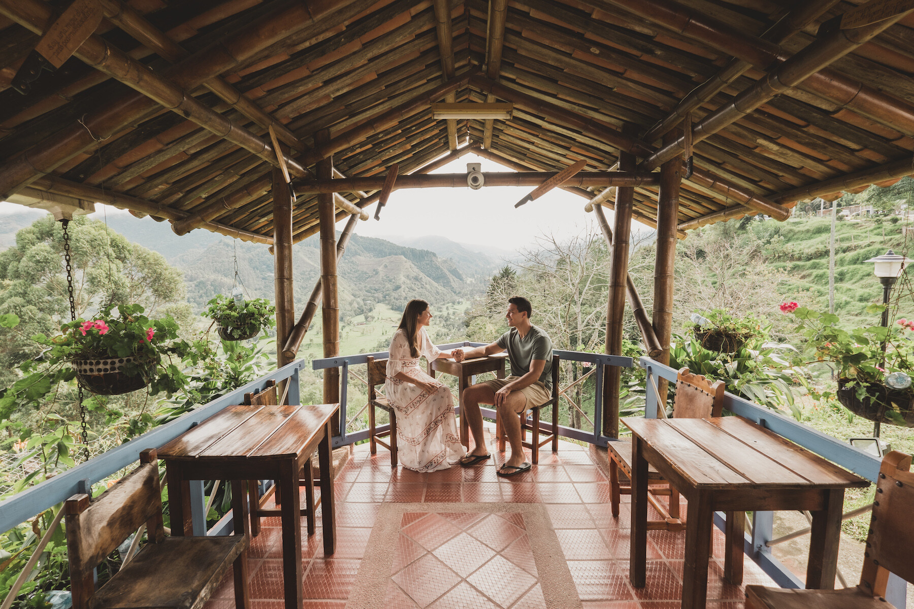 A couple sitting at a rental property in the forest by Cartagena on a couples photoshoot with Flytographer.