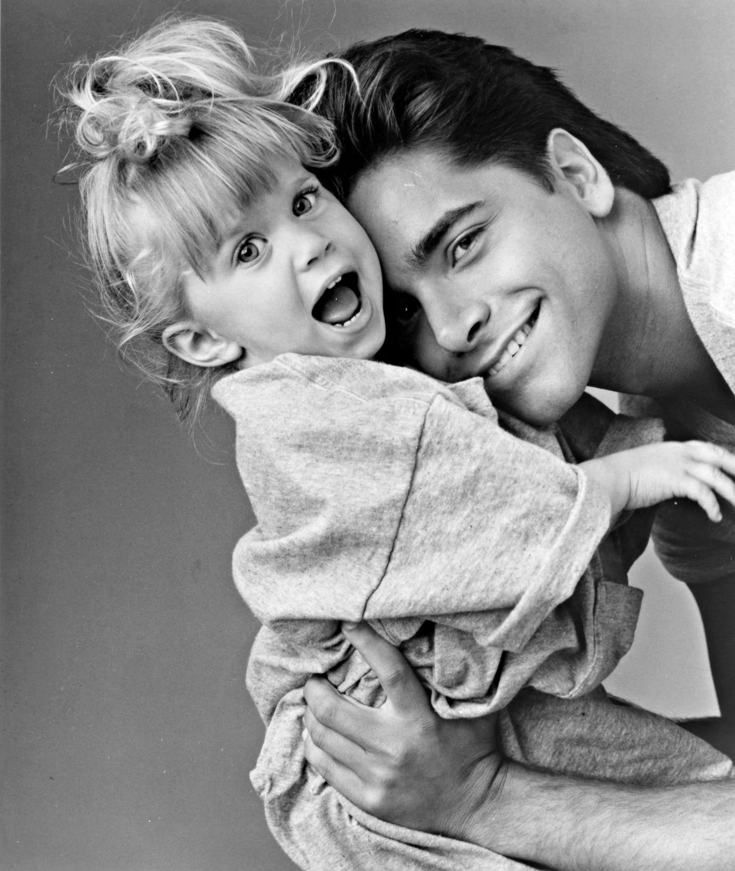 Image may contain John Stamos Face Human Person Baby Hug Female Teen Woman Girl Kid Child Newborn and Photo