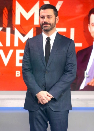 This image may contain Jimmy Kimmel Tie Accessories Accessory Human Person Fashion Suit Coat Clothing and Overcoat