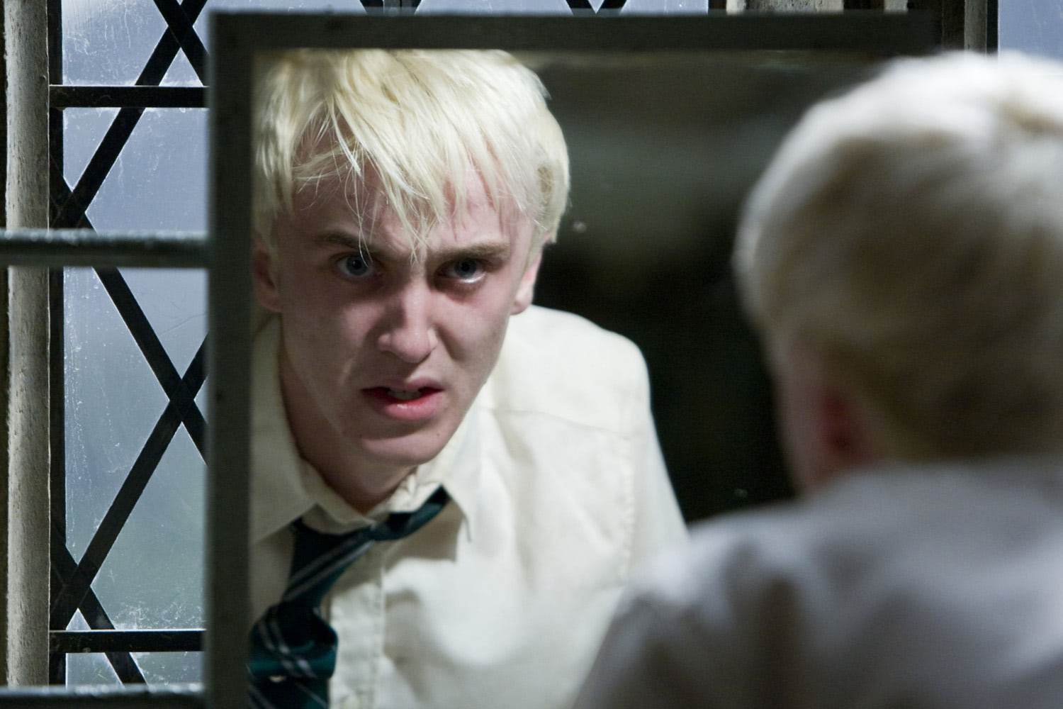 Draco Malfoy looks in the mirror