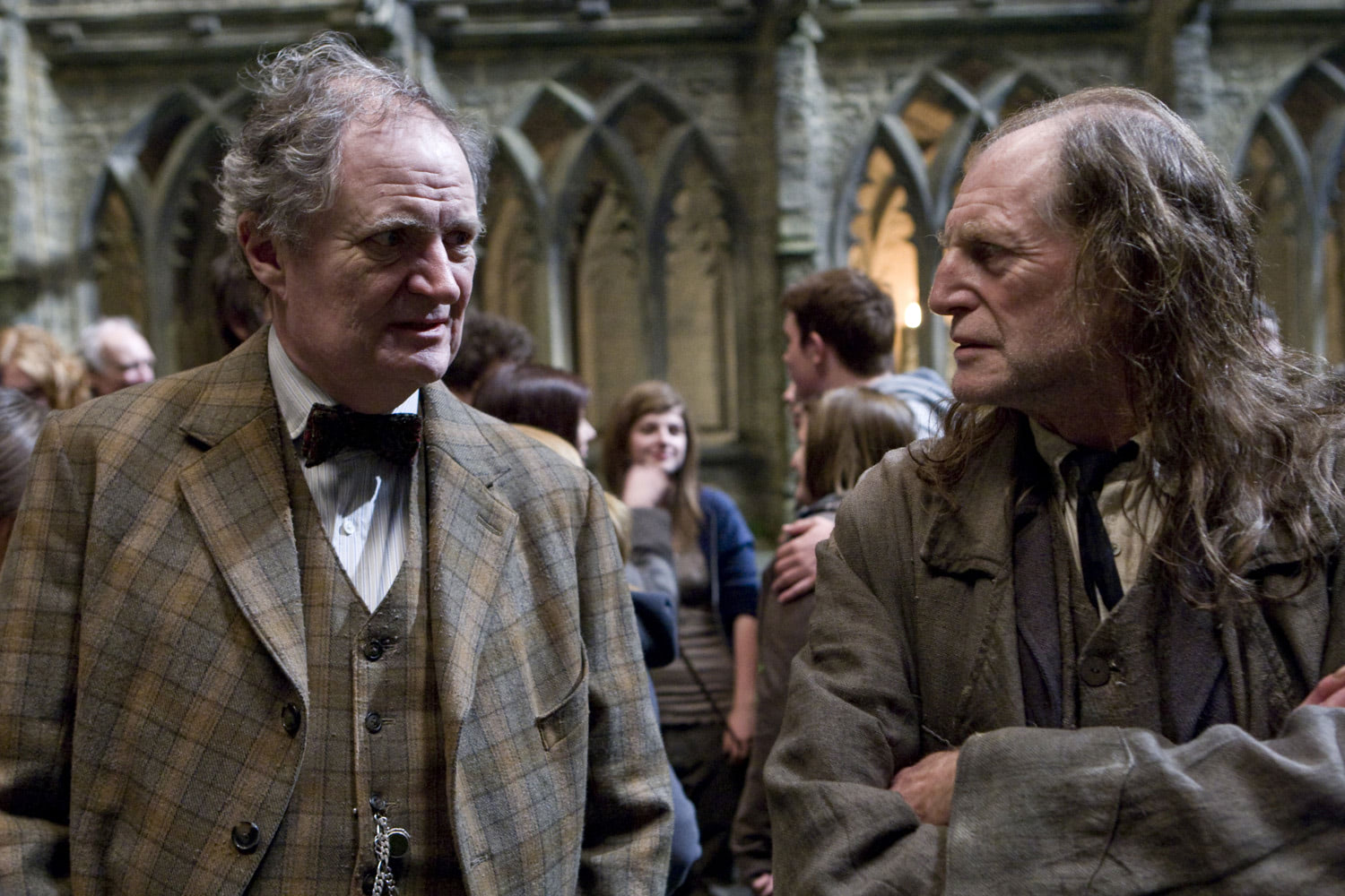 Slughorn and Filch in the grounds