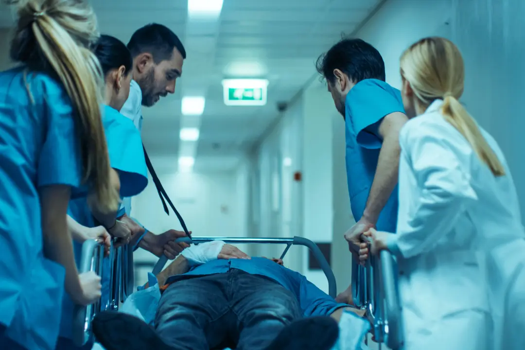 A group of doctors rushing a patient to the emergency room