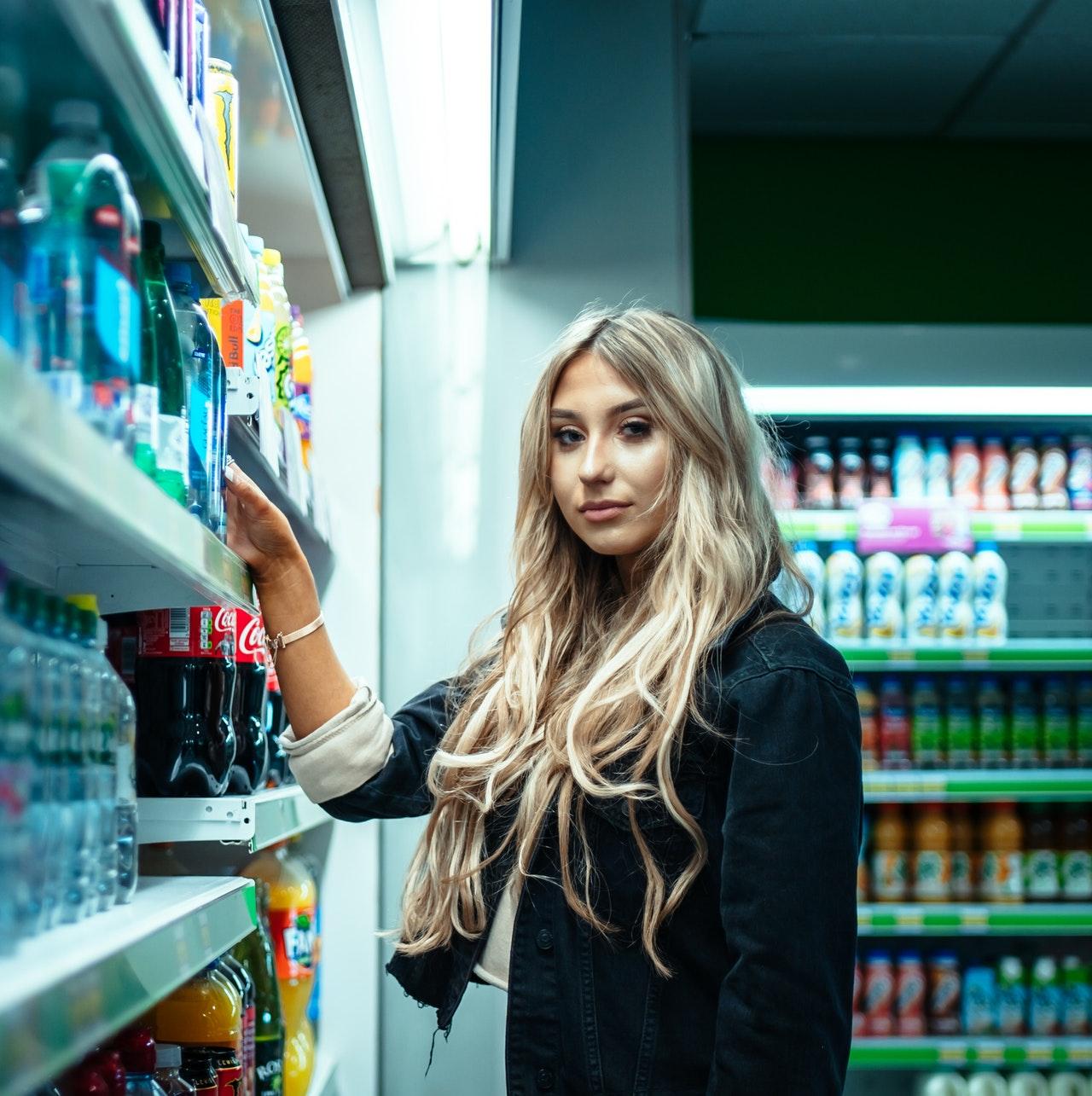 A shopper standing beside a store shelf