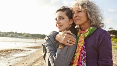 mom and daughter walking on beach who need to prepare for women’s retirement factors