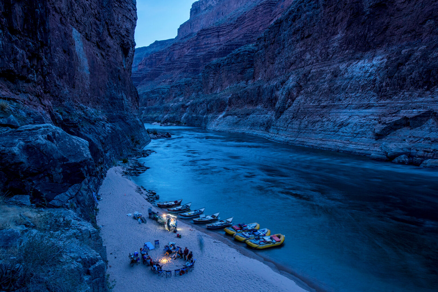 OARS rafts and dories stop to camp for the night deep in Grand Canyon